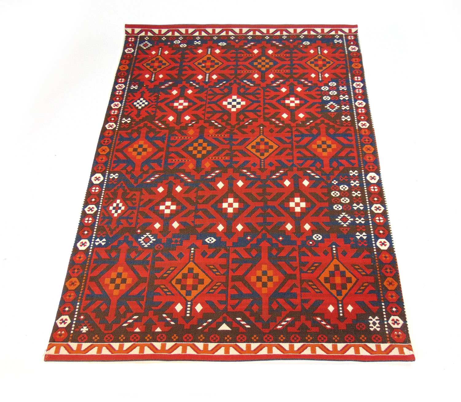 A modern handwoven Turkish rug, the border surrounding the red ground field with geometric design,
