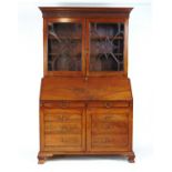 A late 18th century mahogany bureau bookcase, the dentil cornice over two astragal glazed doors