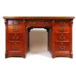 A late Victorian oak free standing twin pedestal desk, the top with a brown tooled leather insert