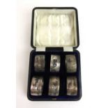 A cased set of six eastern white metal niello work napkin rings. Approx weight 117g