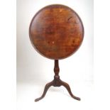 An 18th century mahogany tilt top tripod table, the dish top on turned column, h. 68 cm, dia. 56