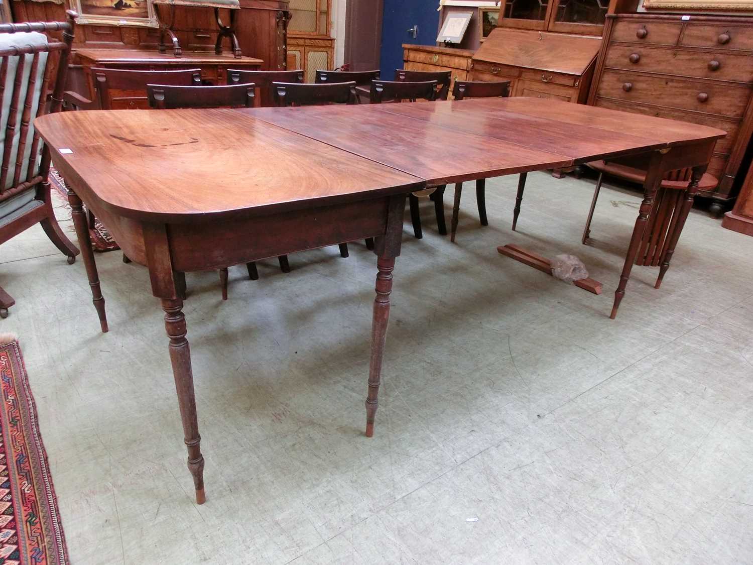 An early 19th century and later mahogany extending dining table, the two D-ends on turned legs - Image 5 of 16