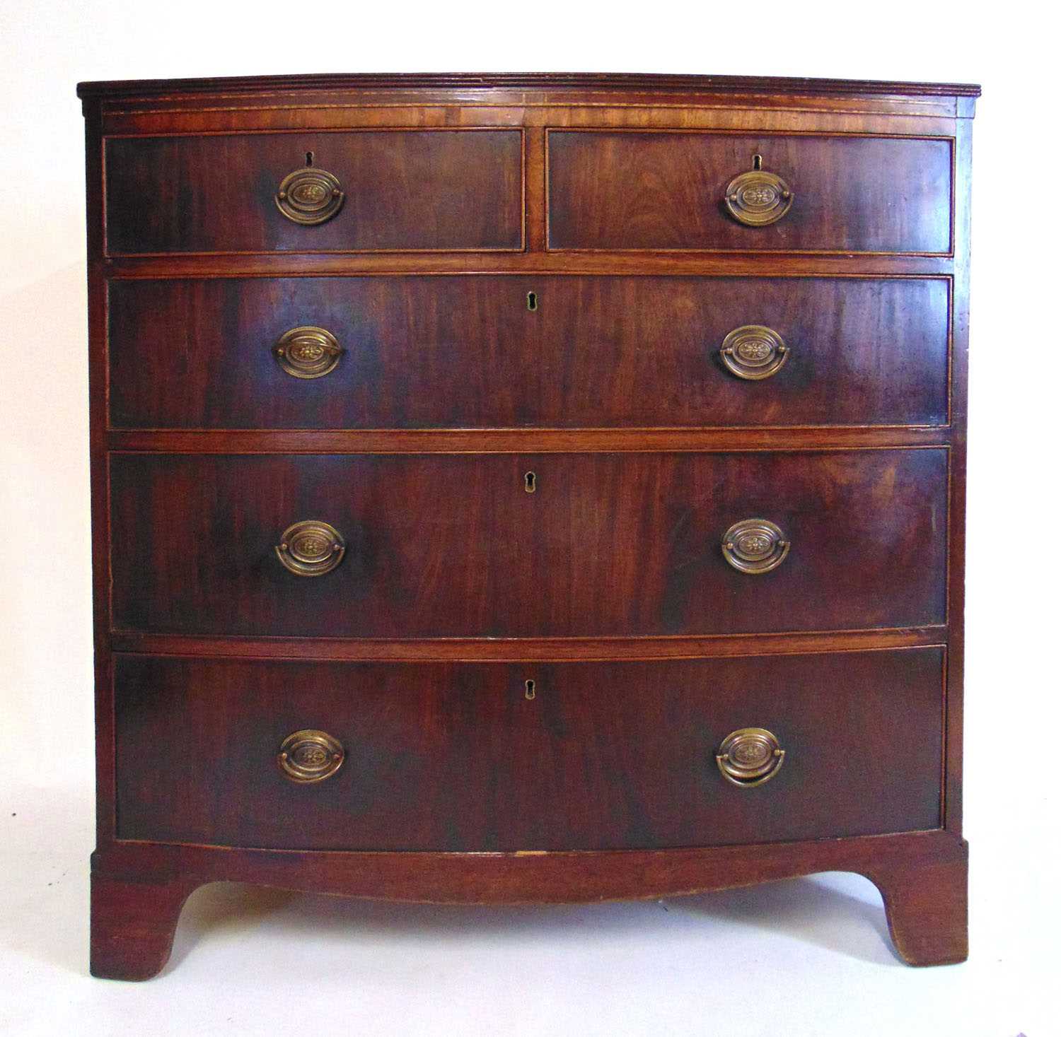 A late 18th century mahogany bow front chest of two short over three long drawers on bracket feet,