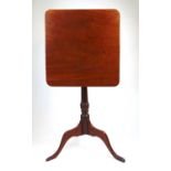 An early 19th century mahogany tilt top tripod table, the rectangular top on a turned column, h.