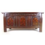 A mid 17th century oak and marquetry coffer, the top lifting to reveal a vacant interior over the