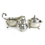 A George V silver sauce boat together with a silver sugar bowl and a small Elizabeth II silver