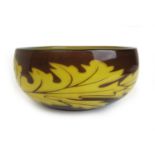 A later 20th century Orrefors art glass bowl decorated in a brown and yellow leaf design.