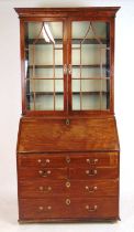 A mid 18th century walnut bureau bookcase, the cavetto cornice over two astragal glazed doors