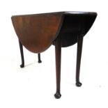 An 18th century mahogany drop leaf table, the circular top supported on a single gate action on