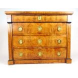 An early 19th century French Empire possibly pear wood chest of four long drawers, the drawers