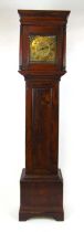 An 18th century elm and oak long case clock, the engraved brass face with single hand and Roman