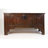 A 17th century oak coffer, the top lifting to reveal a vacant interior with candle box over the four