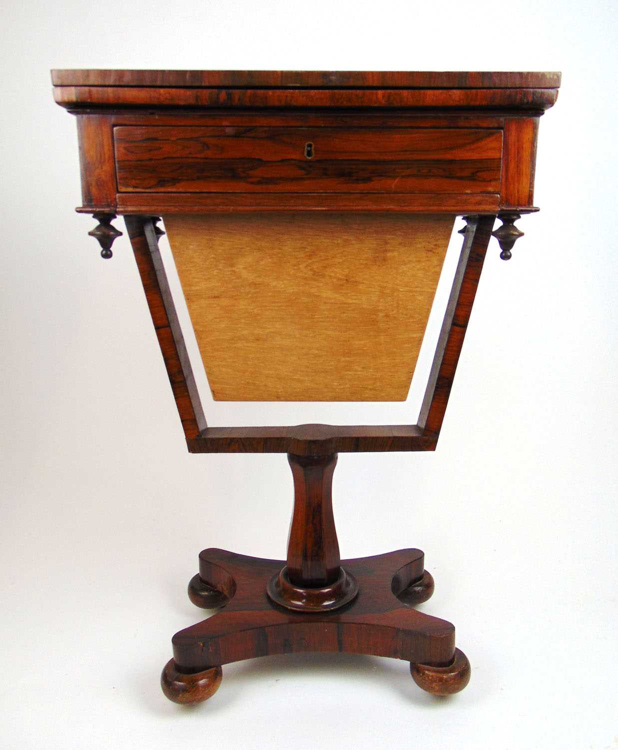 An early 19th century rosewood games/work table, the fold over top with an inlaid chess board