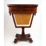 An early 19th century rosewood games/work table, the fold over top with an inlaid chess board