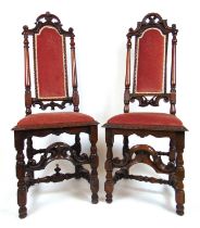 A matched pair of Continental early 18th century walnut side chairs upholstered in a pink fabric, h.