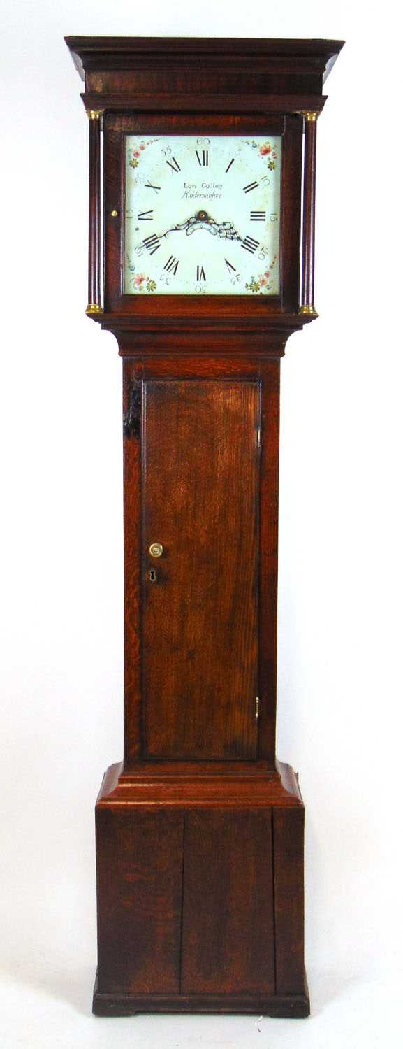 An 18th century oak long case clock, the enameled face with painted spandrels, Roman and Arabic