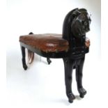An early 20th century Egyptian revival lion stool, the spelter lion mask over the seat upholstered