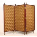 A 19th century walnut three fold screen, the finials over patterned fabric panels on turned feet and