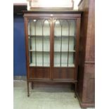 An early 20th century mahogany and tulip wood strung display cabinet, two astragal glazed doors