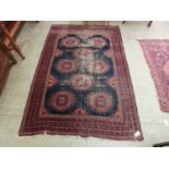 A hand woven Turkish rug, the multi line border enclosing a blue ground field (A/F)