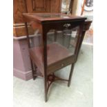 An early 20th century mahogany and strung display cabinet, the lift up top over glazed sides and