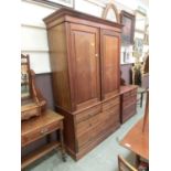 An Edwardian walnut wardrobe, two panelled doors over two short and two long drawers