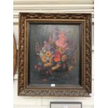 A framed oil on board of still life signed bottom right