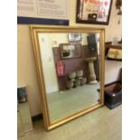 A large ornate gilt framed bevel glass mirror