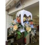 A white ceramic ceiling hanging display of dried flowers