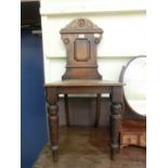 A late 19th century walnut hall chair