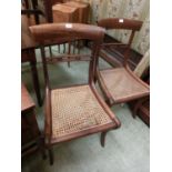 A pair of Victorian rail back dining chairs with cane seats