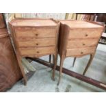 A pair of continental style bedside chests of three drawers