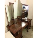 A mid-20th century drop well dressing table having triple mirror to back supported on ball and