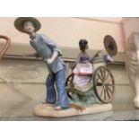 A Lladro figurine of oriental gentleman pulling lady's carriage