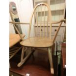 A light Ercol spindle back open arm rocking chair