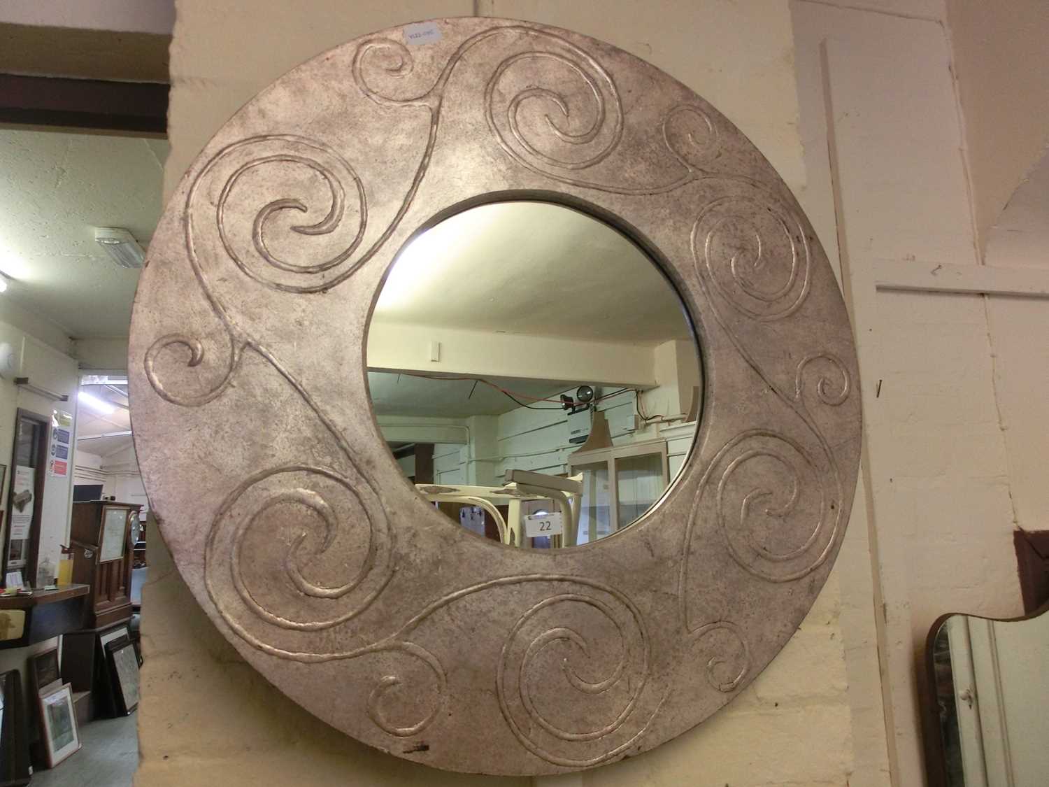 A modern circular framed mirror