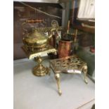 A selection of brass and copperware to include an embossed mirror, fireside companion set, kettle,