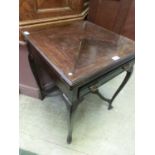 An early 20th century stained mahogany envelope games table