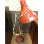 A red angle poise style lamp