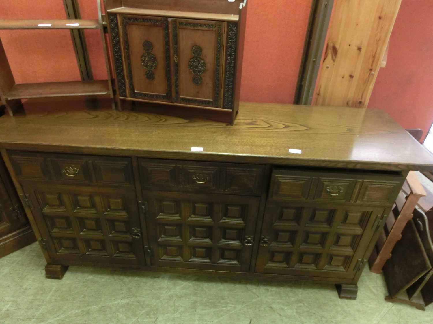 A Spanish oak dresser base having three drawers above panelled doors