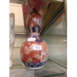 An oriental red and blue decorated vase having a waste side (A/F)