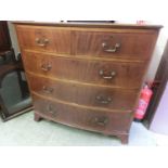 A mahogany inlaid bow front chest of two short over three long drawers on bracket feet