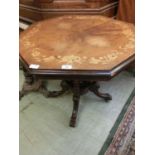 An Edwardian walnut extendable table having a leaf inlay to top on turned wooden support