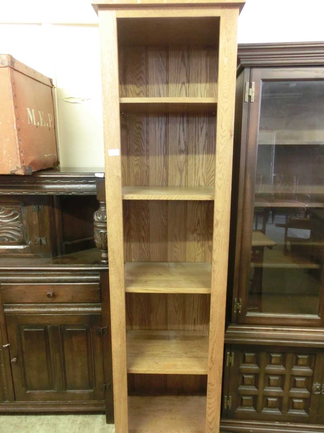 A modern oak full height slimline bookcase