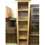 A modern oak full height slimline bookcase