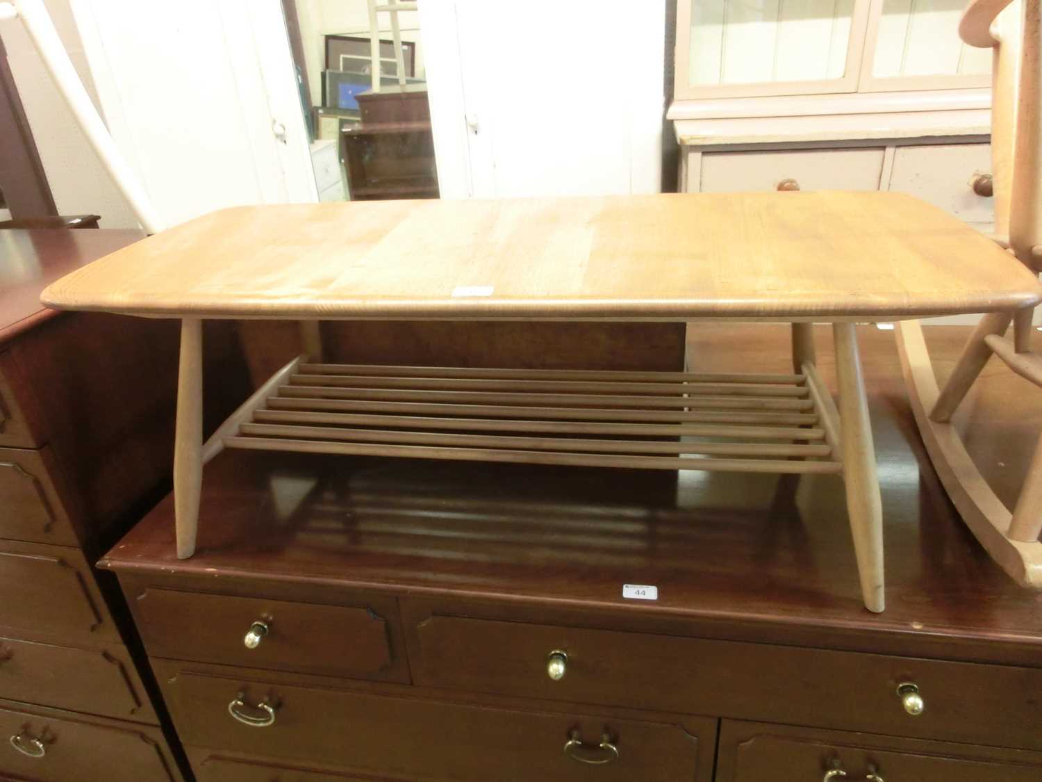 A light Ercol coffee table having a spindle under tierKnocks and scratches to surface. No major