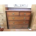 An early 20th century walnut chest of two short over three long drawers