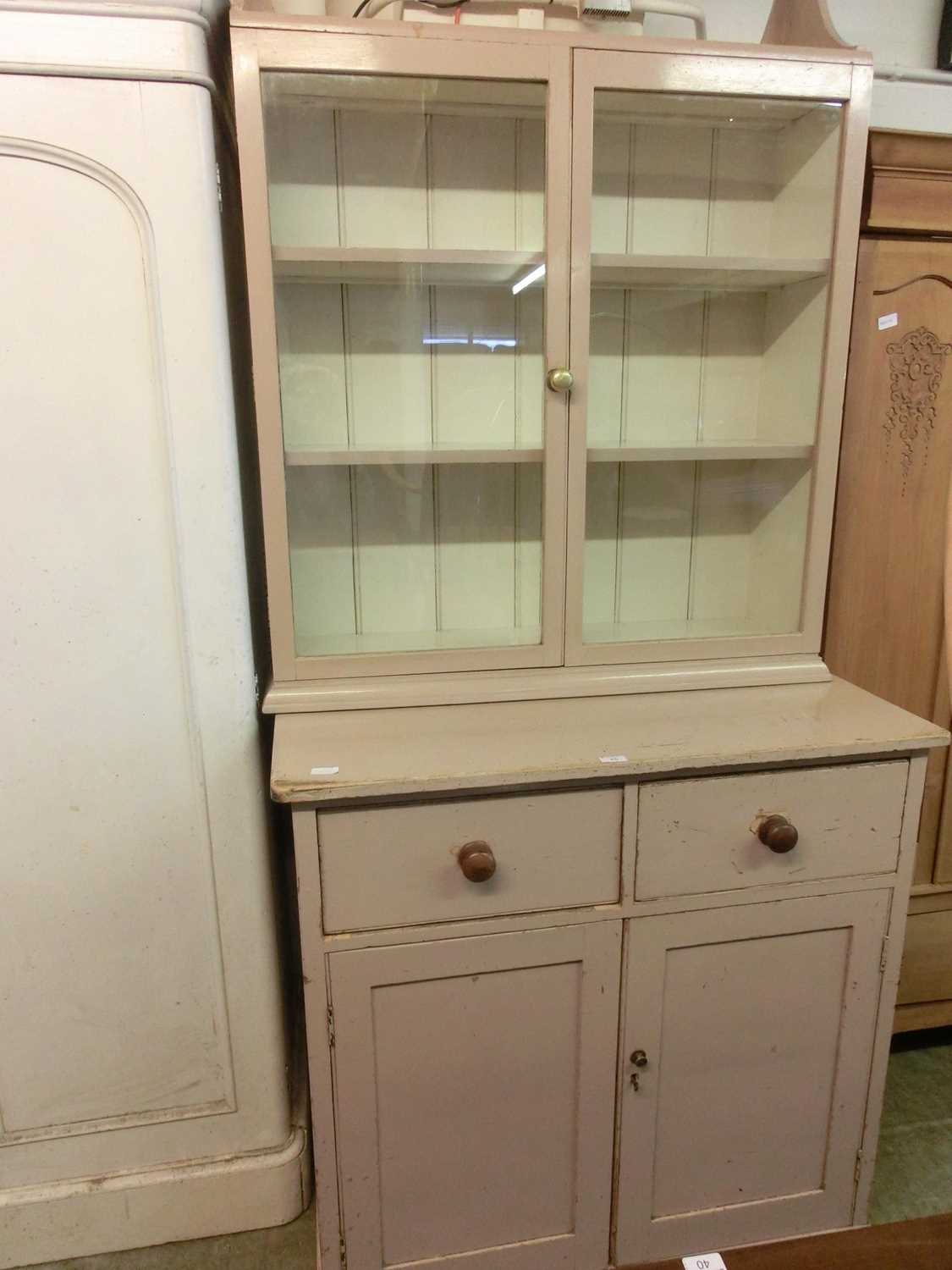 An early 20th century painted pine dresser, the base having two drawers over cupboard doors, the top