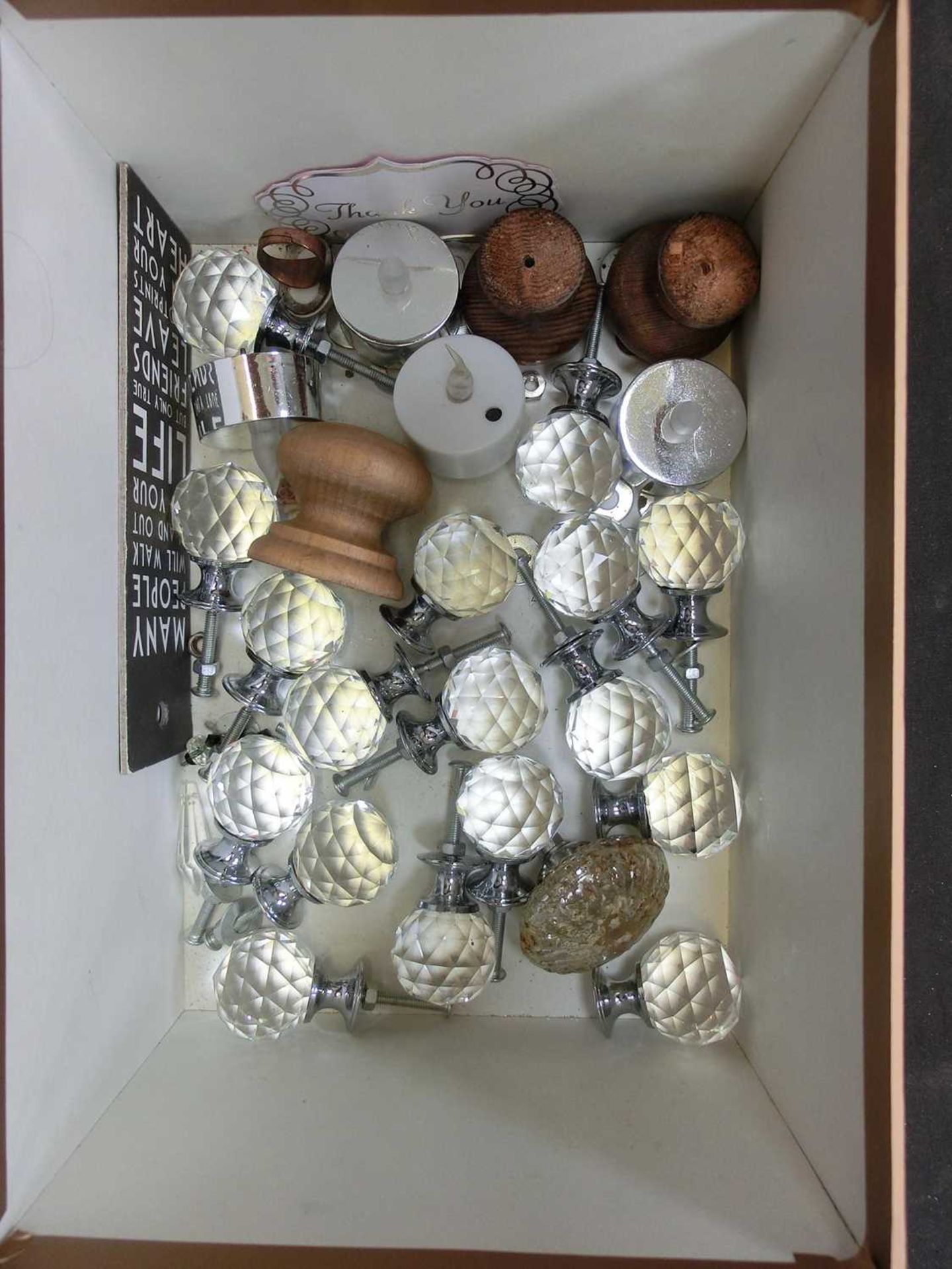 A box containing doorknobs