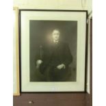 A framed and glazed photographic print of a seated stately gentleman